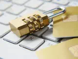 Padlock on a keyboard with credit cards